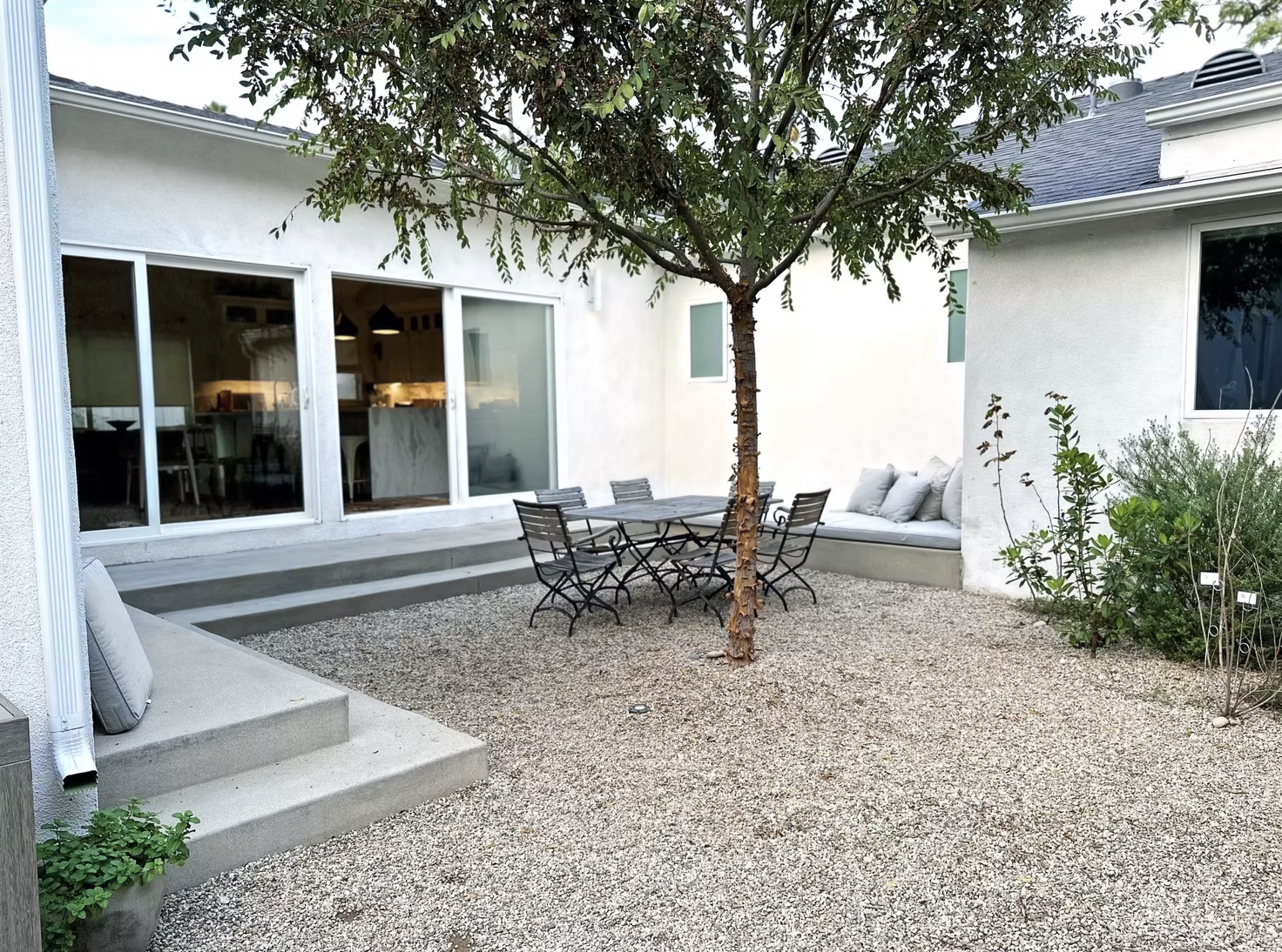 Backyard garden with native plantings and gravel pathways
